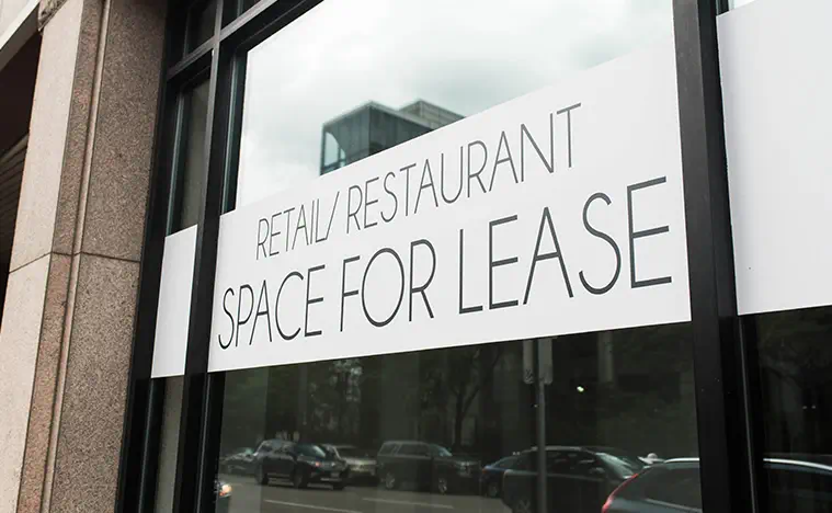 Retail Restaurant space for lease sign displayed in a window.